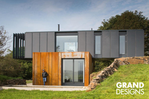 Grand Design by Kevin McCloud. This series takes you though the journey of building a sustainable home from scratch - designing, financing, haggling, fights & disagreements to the final achievement by common folks.
